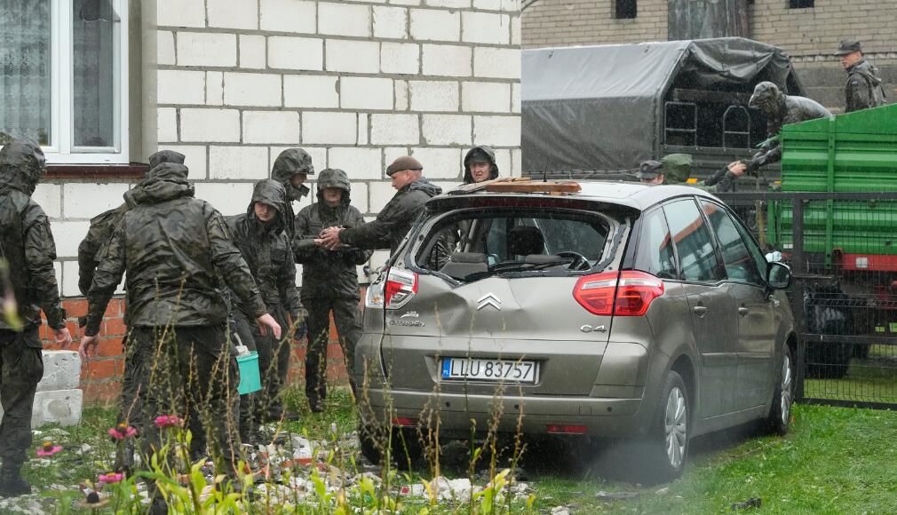 Lenkijos pareigūnai apžiūri įvykio vietą prie apgriauto namo po to, kai Rusijos dronai įsibrovė į šios NATO šalies oro erdvę.