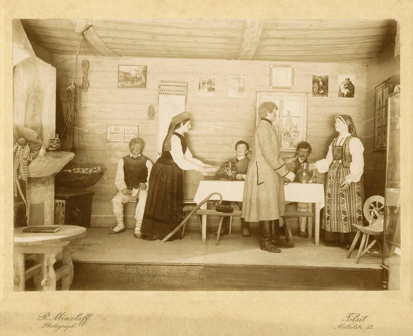 Pristatymas: ūkininko pirkios kambarys su kraitine skrynia kairėje 1900 m. pasaulinėje parodoje Paryžiuje.