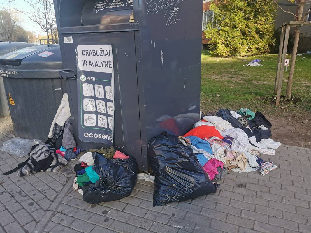 Netvarka: prie Ievos Simonaitytės gatvėje esančio tekstilės konteinerio mėtosi kalnai drabužių.