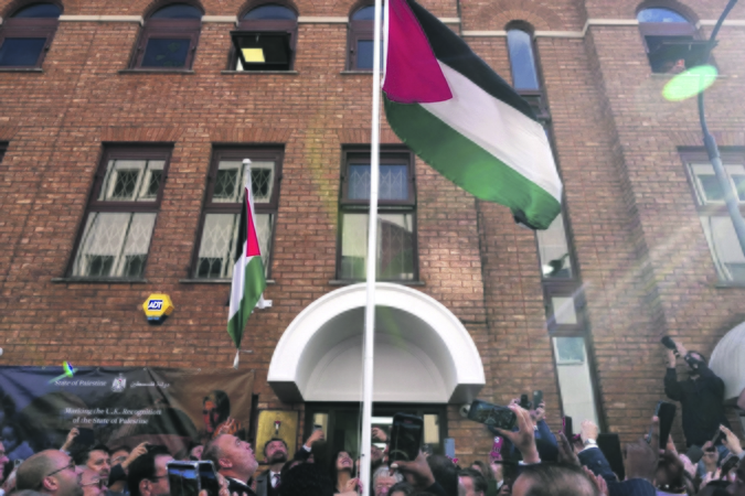 Simbolis: stebint džiūgaujančiai miniai, pirmadienį prie Londone esančios Palestinos atstovybės pastato misijos vadovas Husamas Zomlotas iškėlė Palestinos vėliavą.